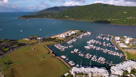 Aerial-View-of-Airlie-Beach-Marina,-Queensland,-Australia-on-Sunny-Evening,-Drone-Shot