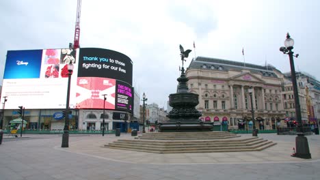 Lockdown-in-London,-Piccadilly-Circus-completely-empty-during-the-corona-virus-pandemic-2020,-with-COVID-19-messages-on-the-LG-LED-signs