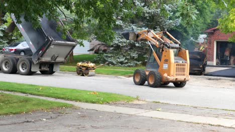 A-combination-of-heavy-equipment-and-manual-labour-is-required-as-a-residential-driveway-is-being-constructed