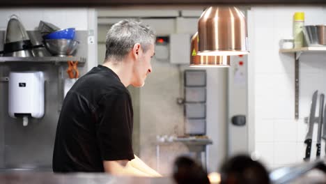 Slow-motion-shot-of-an-experienced-chef-whisking-food-whilst-chatting