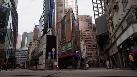 Hong-Kong-street-view-with-passing-by-taxi-and-other-cars-and-futuristic-high-buildings-on-the-background