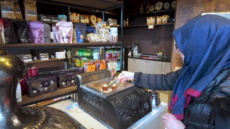 Trabzon,-Turkey:-A-Turkish-woman-preparing-coffee-in-the-traditional-way,-highlighting-cultural-heritage-and-the-rich-aroma-of-freshly-brewed-Turkish-coffee