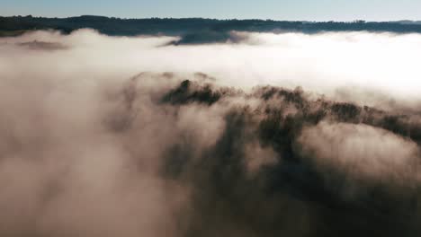Mist-on-a-cliff-and-forest,-drone-shot-at-La-Roque-Saint-Christophe-in-Dordogne,-Périgord---France