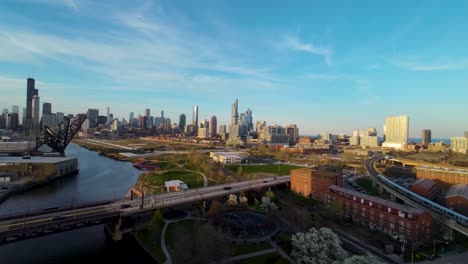 aerial-drone-footage-of-the-Chicago-Chinatown-cityscape-with-river,-bridge,-and-skyscrapers-during-golden-hour