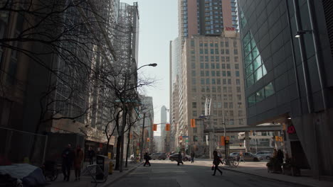 Walking-towards-Dundas-street-on-a-busy,-sunny-day-in-Toronto,-Canada