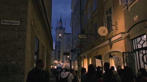 Salzburg,-Austria-–-October-11,-2019:-Shopping-street-at-night-with-crowd-people-in-Salzburg