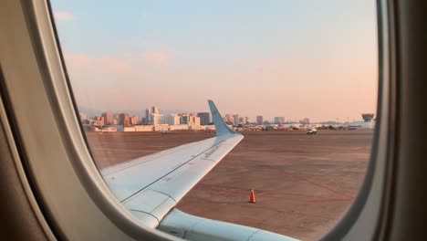 View-Of-Aeromexico-Airplane-Wing-In-Guatemala-City-Airport-Before-Departure-During-Beautiful-Golden-Hour-Sunset-And-City-Skyline-In-Background