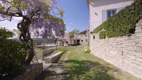 Slow-dolly-shot-revealing-vibrant-trees-at-a-villa-garden-in-Tresques