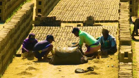 Trabajadores-Dando-Forma-A-Ladrillos-En-Un-Campo-De-Ladrillos-Bañado-Por-El-Sol-En-La-Zona-Rural-De-Bangladesh