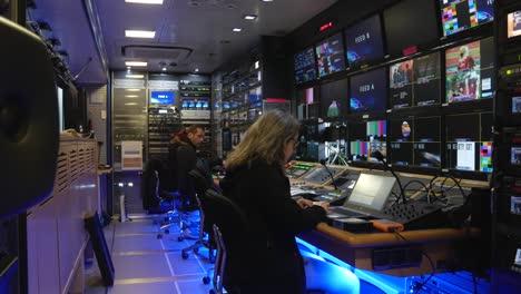 Reveal-shot-of-Broadcast-truck-interior-with-people-working-on-broadcast-production---Portugal