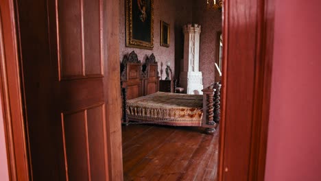 The-Count-Bedroom-in-Trakošćan-Castle,-featuring-ornate-wooden-furniture-and-a-lavish-bed-with-an-intricate-design