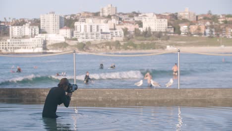 Surf-Photography-Concept---photographer-taking-pictures-of-Surfers-in-North-Bondi-Beach-in-Australia