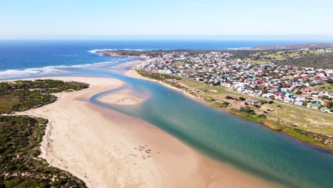 Scenic-aerial-view-over-Goukou-estuary-mouth-and-Still-Bay-west,-South-Africa