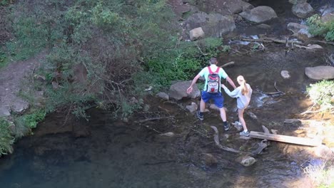 Looking-down-on-two-walkers-crossing-shallow-stream-at-the-Blue-Mountains-Australia