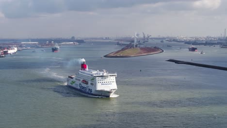 Drone-view-of-ferryboat-cruising-out-of-busy-industrial-Rotterdam-seaport