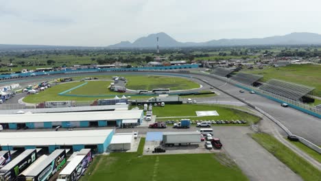 Aerial-view-over-Sports-cars-racing-in-racetrack-in-Puebla,-Mexico