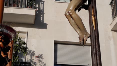 Closeup-of-a-"paso"-float-decoration-depicting-the-mutilated-body-of-Christ-staked-to-a-cross-during-the-famous-Easter-celebrations-in-Madrid