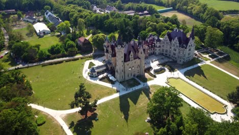 Moszna-Castle-With-Many-Towers-In-Southwestern-Poland---Aerial-Drone-Shot