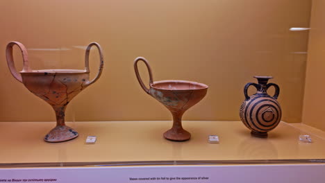 Clay-kylix-pots-restored-and-displayed-on-Museum-of-Ancient-Agora,-secured-Greece-treasure