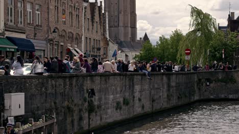 Crowd-Of-People-On-Street-By-The-Dijver-Canal-In-Bruges,-Belgium