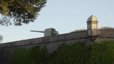 Old-war-canon-standing-on-top-od-the-mirador-montjuic-landmark-viewpoint-in-Barcelona