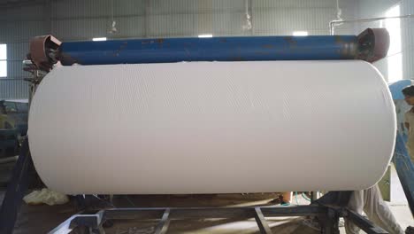 Large-Roll-Of-Fabric-On-Rollers-Inside-Factory-In-Pakistan