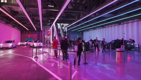 Trade-show-attendees-patiently-queue-for-a-ride-in-the-futuristic-Tesla-Vegas-Loop