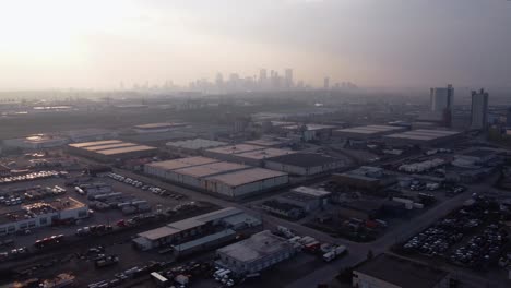 Aerial-drone-shot-of-downtown-Calgary-covered-in-wildfire-smoke
