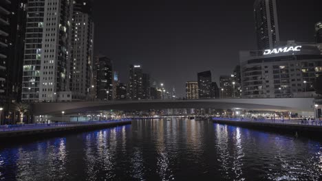 Tranquil-night-cruise-beneath-Dubai-Marina's-bridges