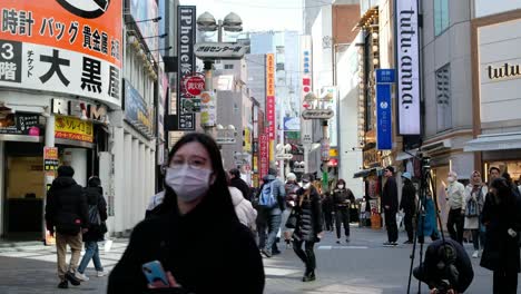 Japanese-tourists-shopping,-road-crossing,-using-transportation-in-Akihabara,-Tokyo,-browsing-the-latest-games-and-exclusive-merchandise-amid-the-vibrant-atmosphere,-store-opening-in-Japan-4K-30fps