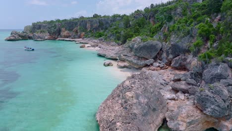 Rocky-coastline-of-jaragua-national-park-with-boat-in-bay