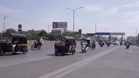 Many-vehicles-are-moving-on-the-road-where-rickshaws-and-bikes-are-visible