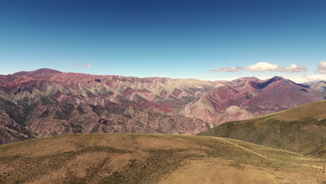 Experience-the-breathtaking-beauty-of-Hornocal's-vibrant-mountain-range-in-Jujuy,-Argentina,-with-this-stunning-aerial-drone-shot