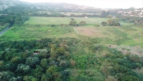 Drone-Volando-Sobre-Un-Canal-Con-Aguas-Residuales-Dirigiéndose-A-Un-Campamento-De-Ocupantes-Ilegales-Con-Chozas