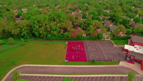 An-aerial-perspective-showcases-a-school-in-Arlington-Heights,-Illinois,-USA,-featuring-visible-sport-terrain-in-its-yard,-epitomizing-the-importance-of-education-and-community-growth