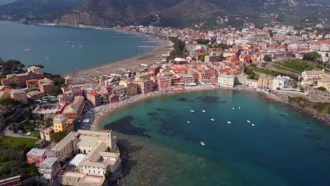 Sestri-levante,-showcasing-vibrant-buildings,-clear-blue-waters,-and-scenic-beaches,-aerial-view