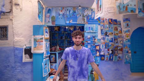 Cheerful-young-guy-exploring-picturesque-blue-streets-of-Chefchaouen