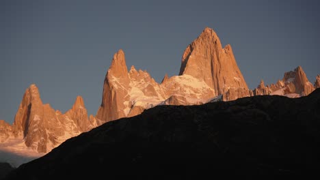 Light-and-shadow-contrast-highlight-Mount-Fitz-Roy-illuminated-by-golden-light-in-Patagonia,-Argentina