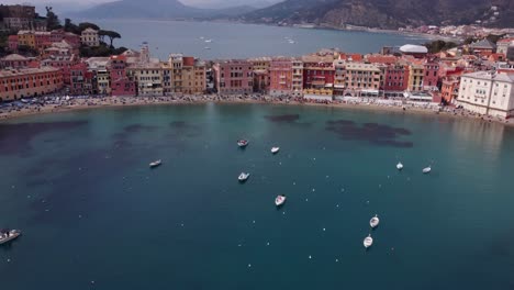 Sestri-levante,-showcasing-its-vibrant-coastal-cityscape-and-turquoise-waters,-drone-shot,-aerial-view