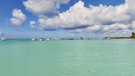 Flying-Towards-The-Yachts-And-Boats-With-Vacationist-Swimming-In-The-Ocean-In-Summer-In-Dominican-Republic