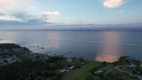 Morning-drone-shot-of-the-Bogue-sound,-coastal-area,-boat-on-the-water