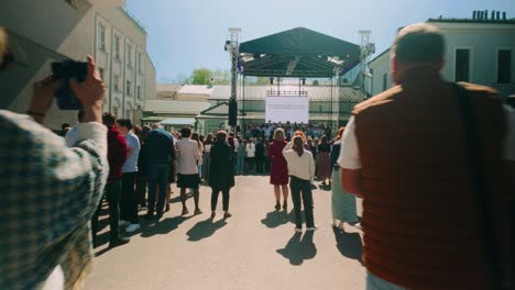 Moving-through-audience-crowd-of-teachers-students-and-alumni-in-front-of-music-stage