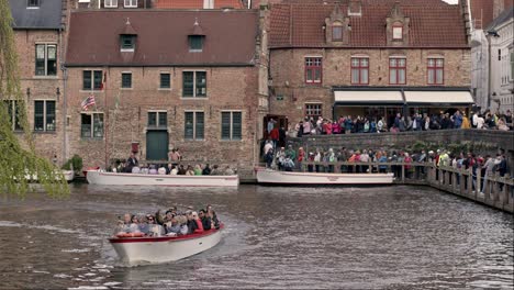 Crowd-Of-Tourists-In-Boats-Touring-On-Dijver-Canal-In-Bruges,-Belgium