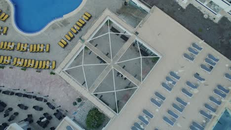 Rotating-aerial-shot-of-a-Melia-Palma-Marina-hotel-with-swimming-pool-in-Mallorca,-Spain