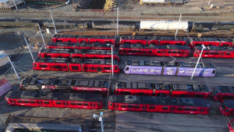 San-Diego-Trolley-Yard-with-Red-Trains-in-aerial-view-slide-right