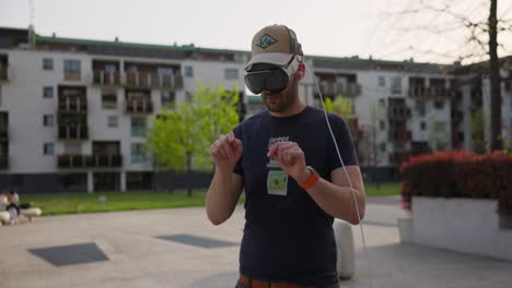 Male-engages-with-a-virtual-world-using-a-mixed-reality-spacial-computer-headset,-using-gesture-to-type-into-thin-air