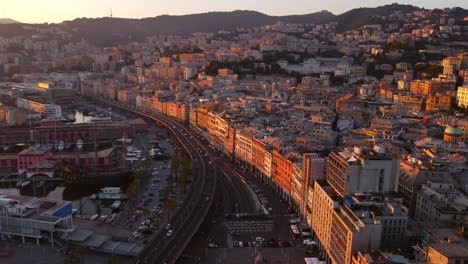 Genoa's-historical-center-at-sunset,-showcasing-the-vibrant-cityscape-and-streets,-aerial-view