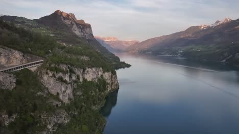 Beautiful-drone-shot-of-the-Walensee-Lake-and-surrounded-mountains,-Part-of-the-lake,-green-hills,-trees