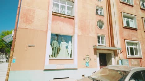 Clothing-store-shop-window-in-retro-Eastern-Europe-appartment-block-in-Baltic-Latgola-capital-Daugavpils