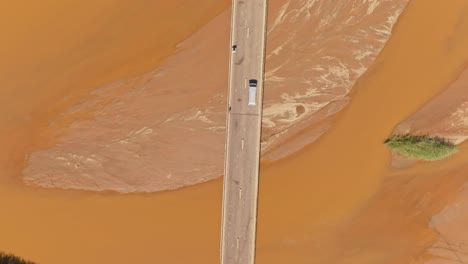 Top-down-view-of-car-crossing-the-bridge-above-Tsiribihina-River-in-Madagascar